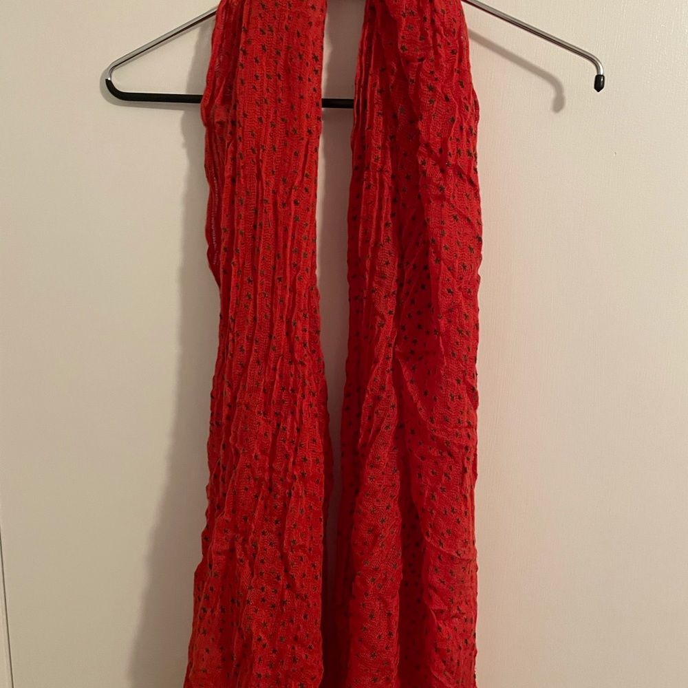 Gauzy red scarf covered with olive green stars